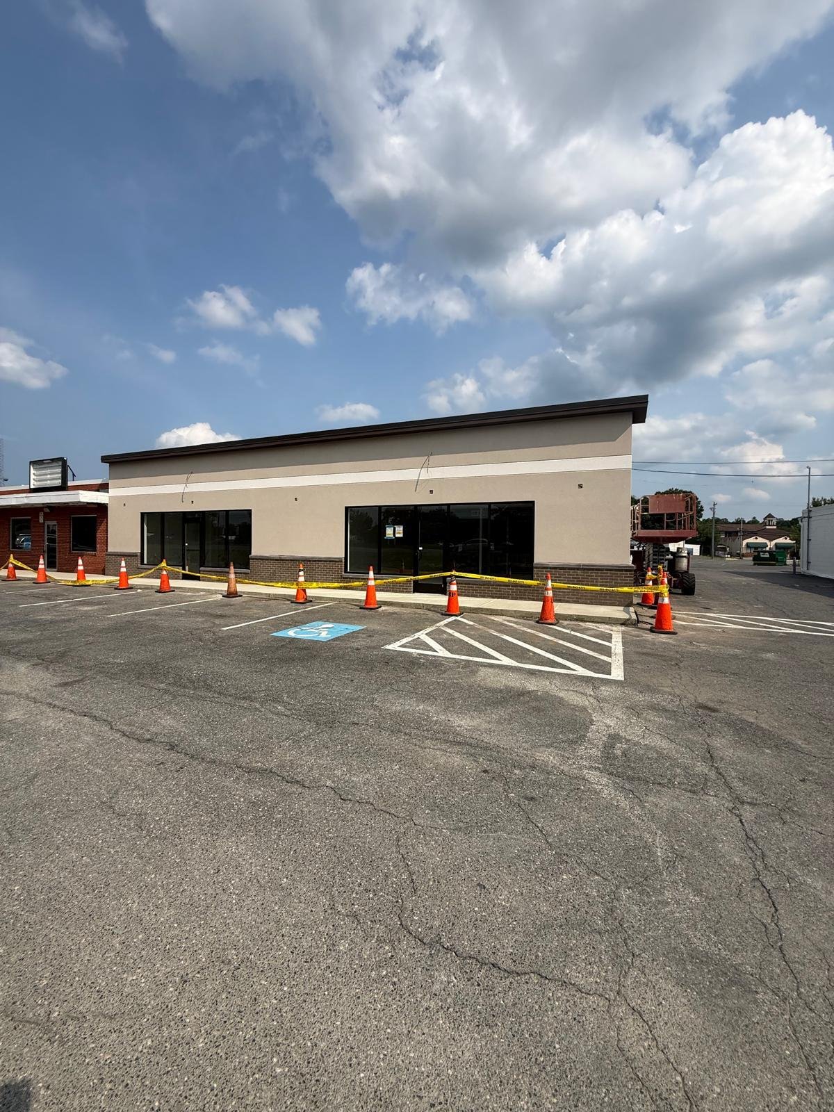Commercial building renovation showing finished exterior facade and active site work